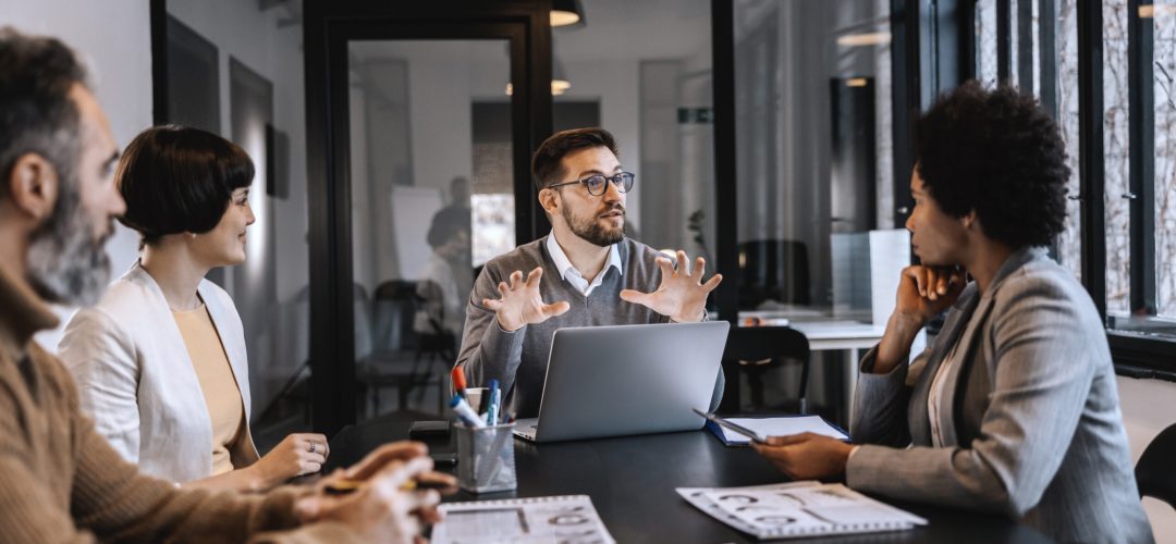 A multiracial team is working on project and discussing start up business at the boardroom.